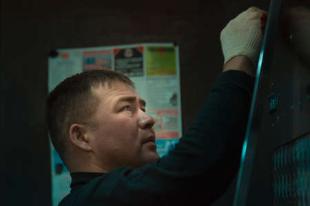 Portrait of a young man in gloves at work