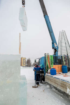 The crane driver raised the ice panel high above the groundの写真素材