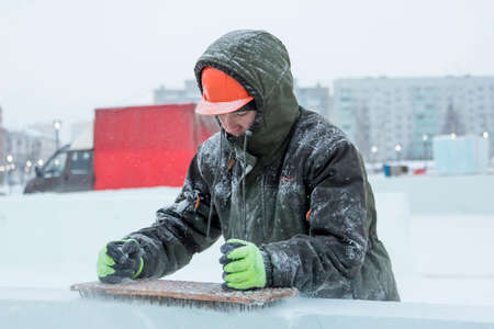 Portrait of a worker at the construction of the ice town for Christmas