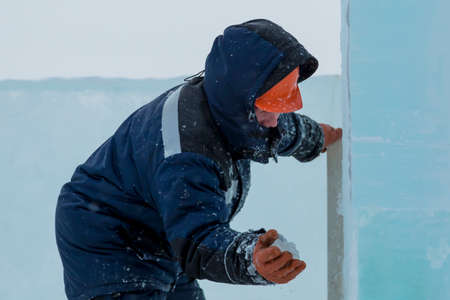 Portrait of a worker at the construction of the ice town for Christmas