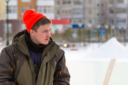 Portrait of an assembler worker in a sports hat in red