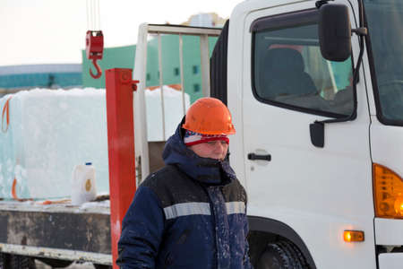 Portrait of a worker walking along the construction site of the ice town