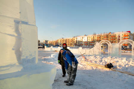 Workers at the construction site of the ice town for a conversation