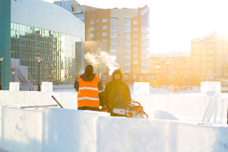 Workers at the construction site of the ice town for a conversation