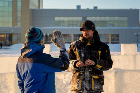 Workers at the construction site of the ice town for a conversation