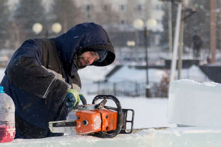 Worker manually fills the saw with gasoline from the canの写真素材