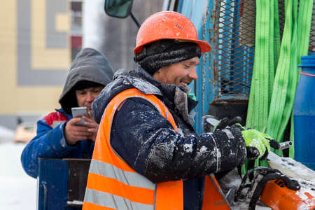 Workers on the construction site of the ice town in a good moodの写真素材