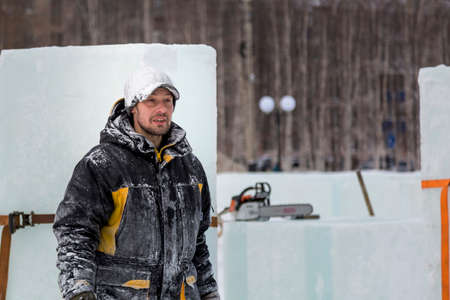 Portrait of an assembler worker in a jacket with a hood at the construction of an ice campの写真素材