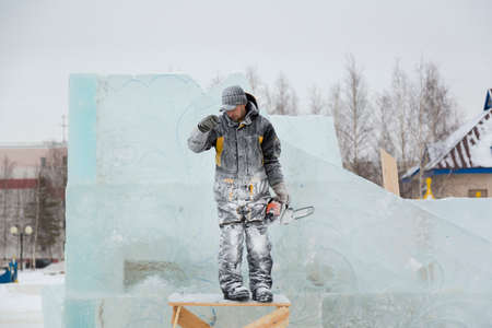 Portrait of an assembler worker in a jacket with a hood at the construction of an ice campの写真素材