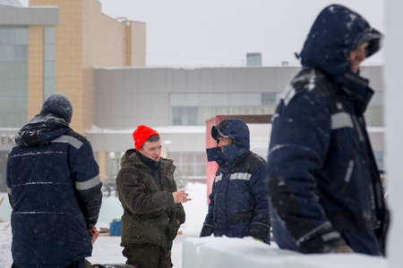 Workers at the construction site of the ice town for a conversation
