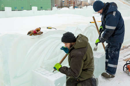 Workers build an ice town for the Christmas holidaysの写真素材