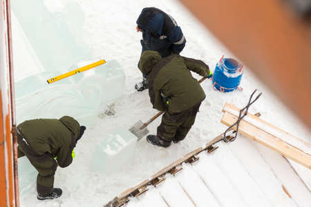 Workers build an ice town for the Christmas holidaysの写真素材