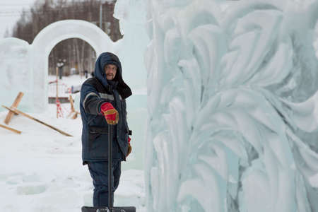 Portrait of a worker at an assembly site of an ice town in winter overallsの写真素材
