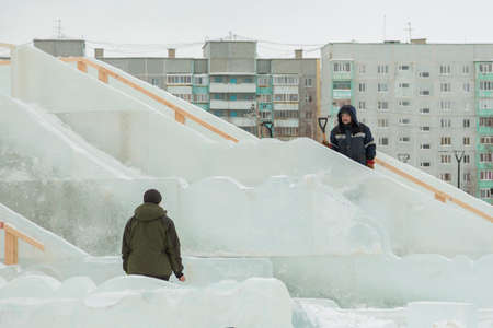 Workers at the construction site of the ice town at work