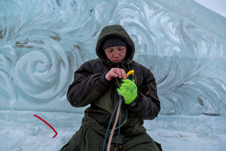 Electrician isolates the ends of the power cable to illuminate the ice figures.の写真素材