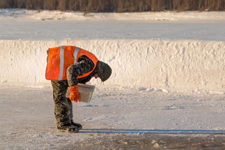 The installer carries in his hands an ice blockの写真素材