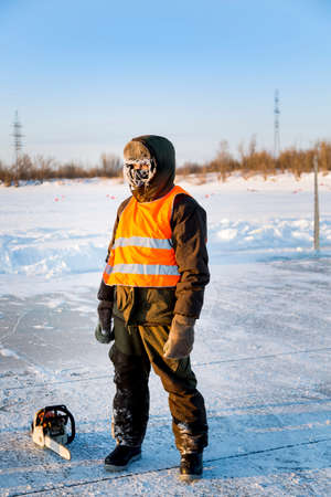 The average plan of the worker in protective overalls, ice of a frozen reservoir, whose face was covered with hoarfrost.の写真素材