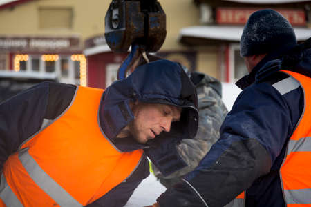 Installers in orange reflective vests on an ice block installation