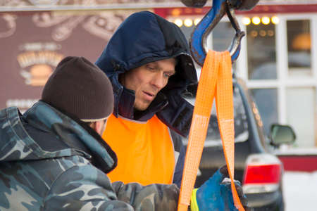 Installers in orange reflective vests on an ice block installation