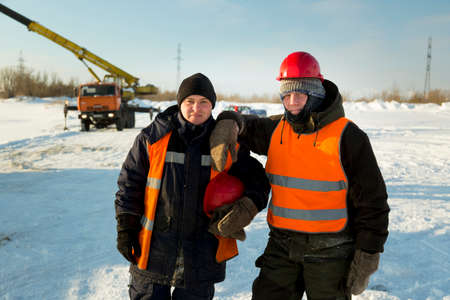 Portrait of workers at a construction site in winter outfit