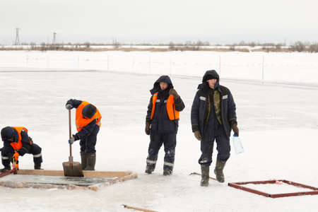 Working rafters prepare ice blocks in the lane for further shipmentの写真素材