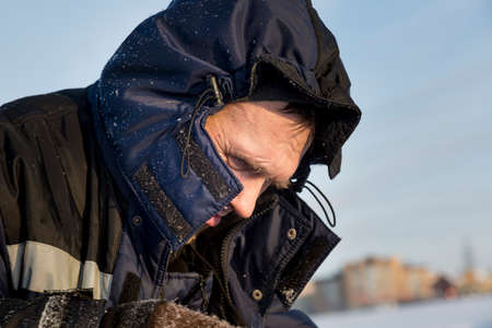 Close-up of a worker's face with a hood on his headの写真素材