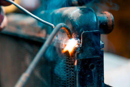 Welding a large car radiator with a gas torch