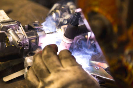 TIG welder to weld aluminum car partの写真素材