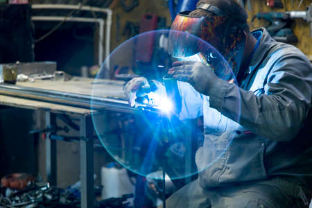 TIG welder welds elbow to polished stainless steel pipeの写真素材