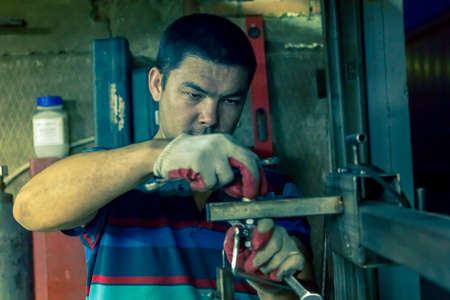 Portrait of male worker close up at workplace