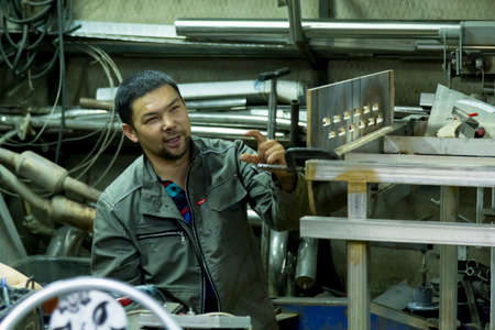 Portrait of male worker close up at workplaceの写真素材