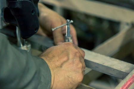 The worker fixes the part to the base with a clamp