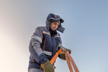 Portrait of a fitter in a blue jacket with a sling