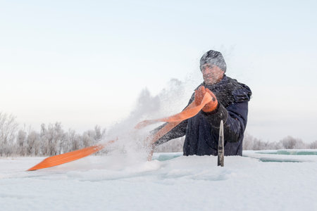Portrait of a worker in a blue jacket with a sling in his hands