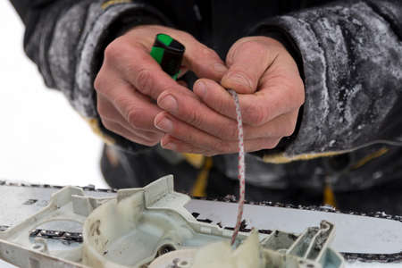Close-up of worker assembler wearing black winter cap at workplace