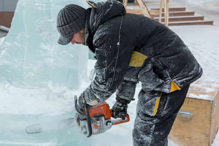 The artist draws the contours of the future ice figure on the ice