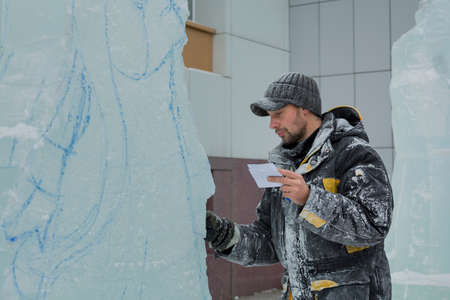 The artist draws the contours of the future ice figure on the iceの写真素材