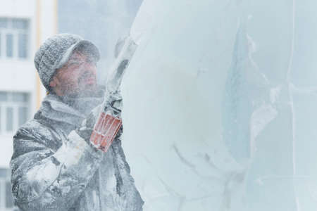 The artist draws the contours of the future ice figure on the ice