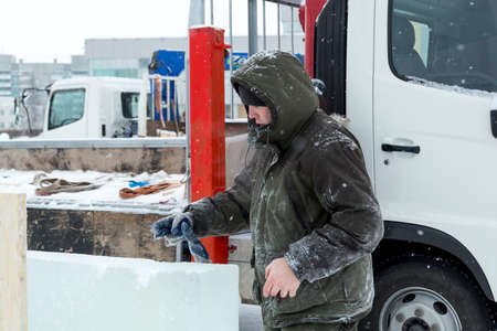 Worker at the construction site of the ice town at the truck craneの写真素材