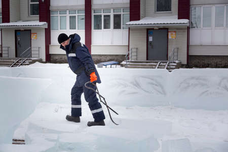 Portrait of a male assembler at the workplace in winter overallsの写真素材