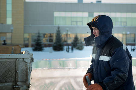 Portrait of a male assembler at the workplace in winter overallsの写真素材