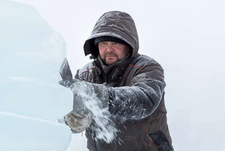 Close-up portrait of a worker on the territory of the ice town
