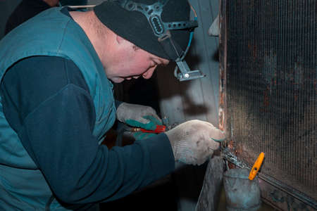 Welding a large car radiator with a gas torch