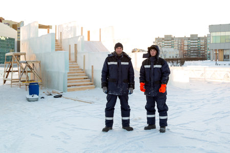 Portrait of two installers at the construction site of the ice townの写真素材