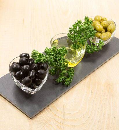 Green and black olives in the bowlsの写真素材