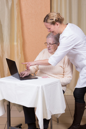 Elderly woman using a laptop computerの写真素材