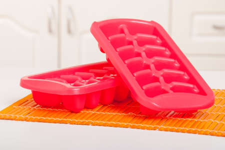 Ice tray in the fridge; photo and white background.の写真素材