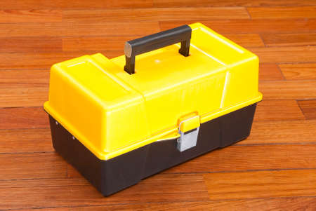 plastic box to organize tools; photo on wooden background.の写真素材