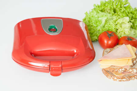 Sandwich maker red with food.