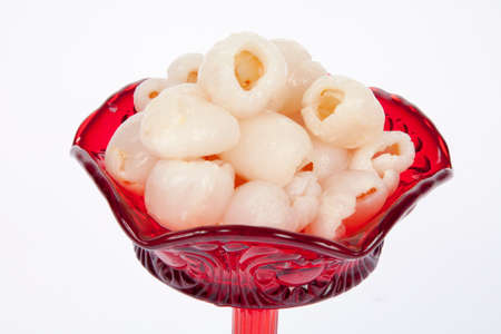 lychees in red bowl on white backgroundの写真素材